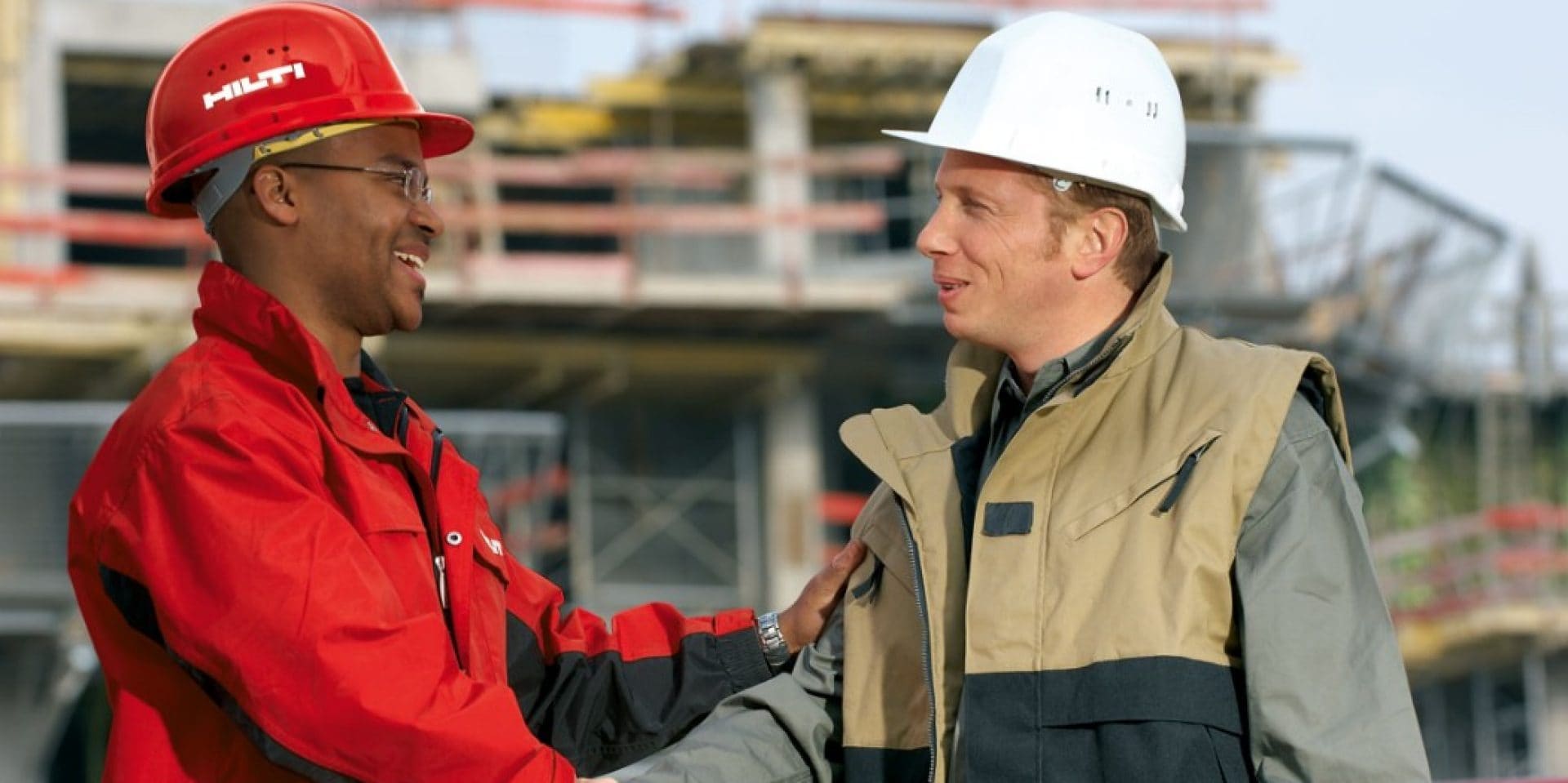 a hilti account manager and a customer shaking hands on a construction jobsite