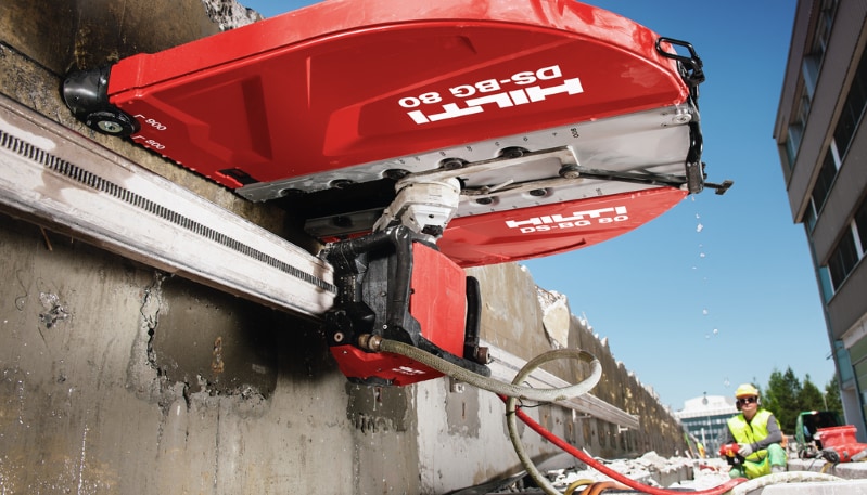 Worker cutting concrete wall with Hilti DST 20-CA
